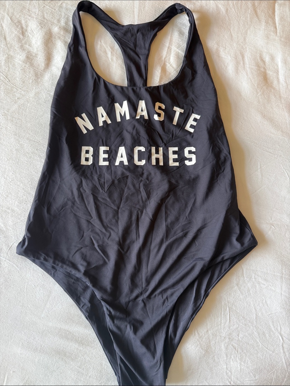 Spiritual Gangster Black One-Piece Swimsuit with White 'Namaste Beaches' Graphic
